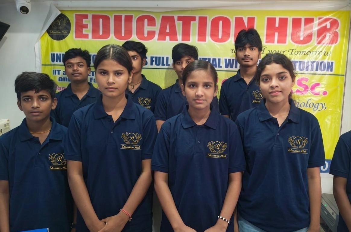 Education Hub students together in institute uniform in front of the academic banner